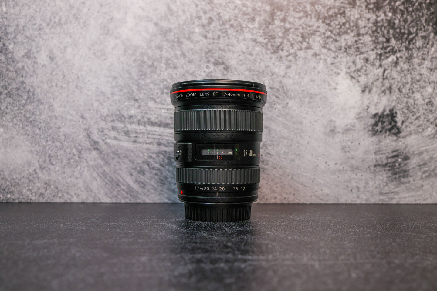 Photo of Canon 17-40mm f/4.0 Lens sitting vertically on the rear lens cap