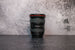 Photo of Canon 17-40mm f/4.0 Lens sitting vertically on the rear lens cap