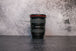Photo of Canon 17-40mm f/4.0 Lens sitting vertically on the rear lens cap