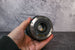Rear element view of a Canon 24-105mm lens being held by a hand