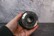 Rear element view of a Canon 24-105mm lens being held by a hand
