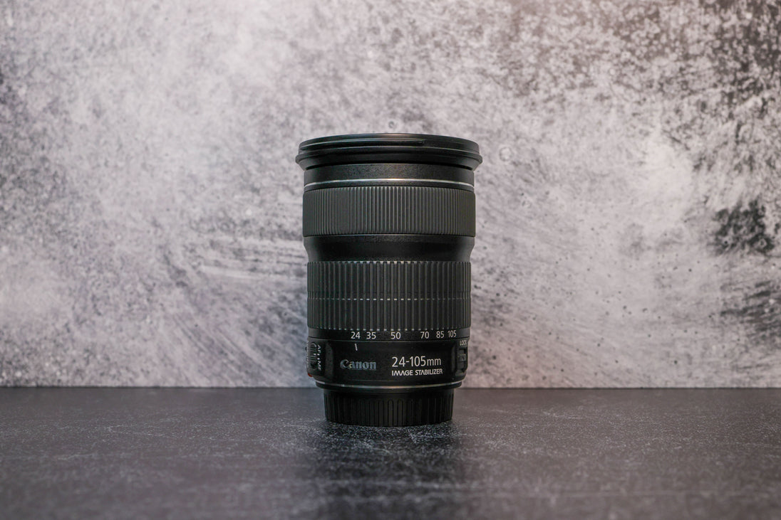 A Canon 24-105mm lens sitting vertically on the rear lens cap
