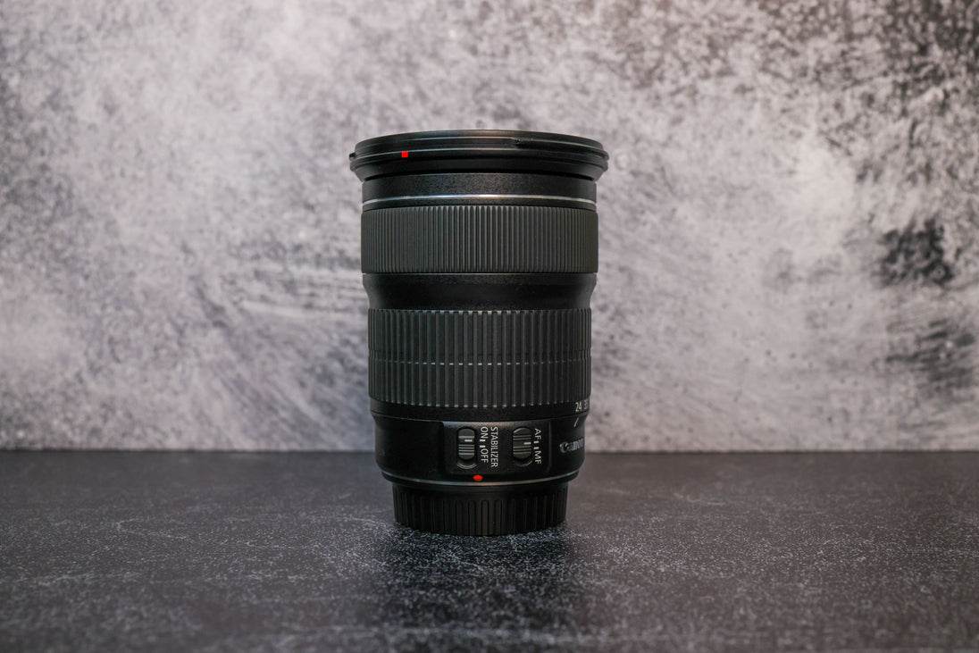 The opposite side angle of a Canon 24-105mm lens sitting vertically on the rear lens cap