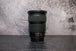 The opposite side angle of a Canon 24-105mm lens sitting vertically on the rear lens cap
